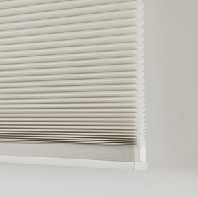 Dual-core cellular shades with honeycomb design for insulation and soundproofing, showcasing unique hole-in-hole construction.